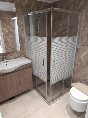 a bathroom with a shower and a toilet and a sink at Lindos Villa Euphoria in Líndos