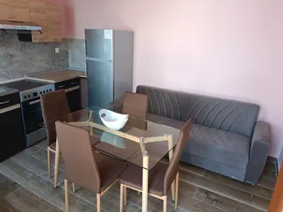 a kitchen with a couch and a table with chairs at Lindos Villa Euphoria in Líndos