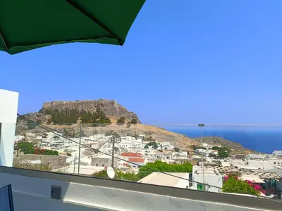 a view of a city with a mountain in the background at Lindos Villa Euphoria in Líndos