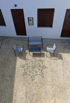 a room with three benches and a wall with two doors at Lindos Villa Euphoria in Líndos