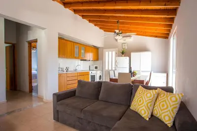 a living room with a couch and a kitchen at Villa Hercules in Kremasti