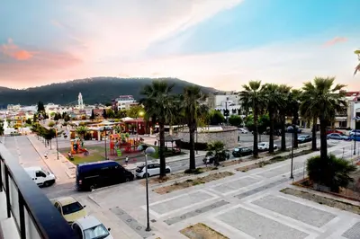 a view of a city with palm trees and a street at Palm Square Appart in Ialyssos