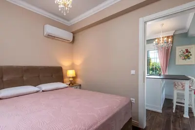 a bedroom with a bed and a table and a window at Cypress View Boutique Villa in Asgourou