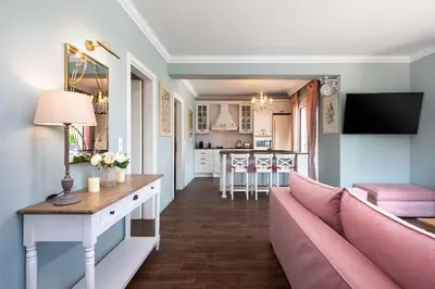 a living room with a couch and a kitchen at Cypress View Boutique Villa in Asgourou
