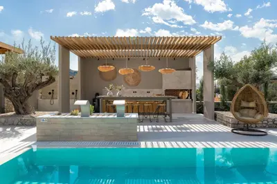 a kitchen and a swimming pool with a villa at Mirena Luxury Living-Casa di Maria in Afantou