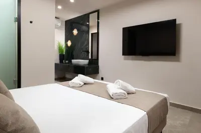 a bedroom with a bed and a flat screen tv at Mirena Luxury Living-Casa di Maria in Afantou