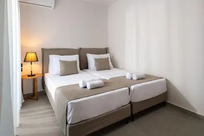 a bedroom with a large bed with two pillows at Mirena Luxury Living-Casa di Maria in Afantou