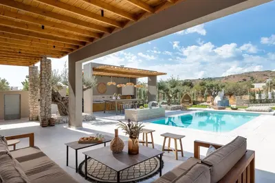 a villa with a swimming pool and a patio at Mirena Luxury Living-Casa di Maria in Afantou