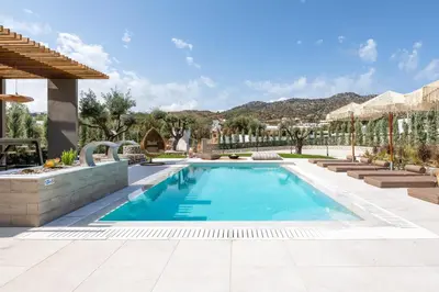 a swimming pool in the middle of a yard at Mirena Luxury Living-Casa di Maria in Afantou