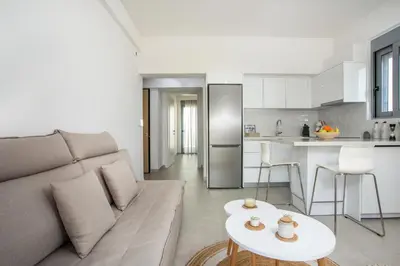 a living room with a couch and a table at Aetheria Central Apartments in Rhodes Town
