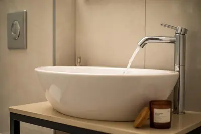 a white sink with a faucet on a table at Aetheria Central Apartments in Rhodes Town