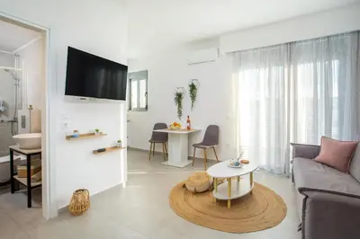 a living room with a couch and a table at Aetheria Central Apartments in Rhodes Town