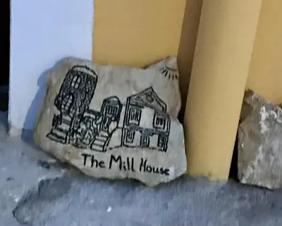 a pillow with a drawing of a mill house on it at The Mill House Stella in Symi