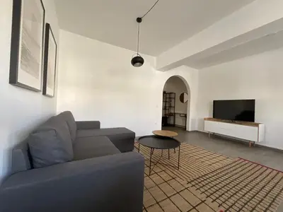 a living room with a couch and a tv at MV central in Rhodes Town