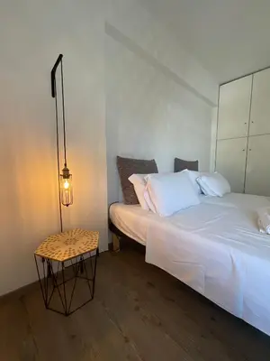 a bedroom with a bed and a side table at MV central in Rhodes Town