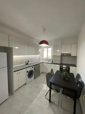 a kitchen with a table and a table and a dining room at MV central in Rhodes Town