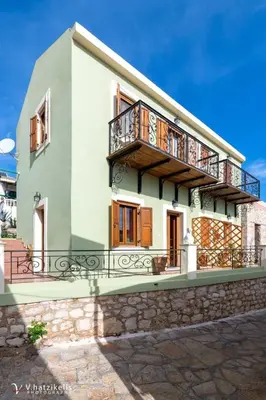 a building with a balcony on top of it at Villa Lola in Halki