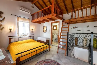 a bedroom with a bunk bed and a staircase at Villa Lola in Halki