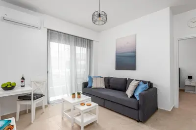 a living room with a couch and a table at Rhodes Retreat & Getaway Apartments in Rhodes Town