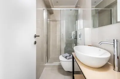 a bathroom with a toilet and a sink and a shower at Rhodes Retreat & Getaway Apartments in Rhodes Town
