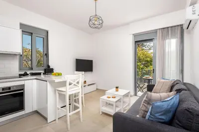 a kitchen and living room with a couch and a table at Rhodes Retreat & Getaway Apartments in Rhodes Town