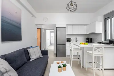 a living room with a couch and a kitchen at Rhodes Retreat & Getaway Apartments in Rhodes Town