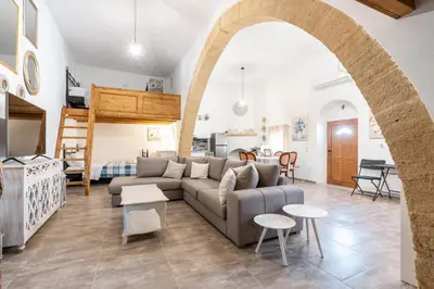 a living room with a couch and a loft bed at Amalia's Traditional Home in Paradisi in Paradeísion