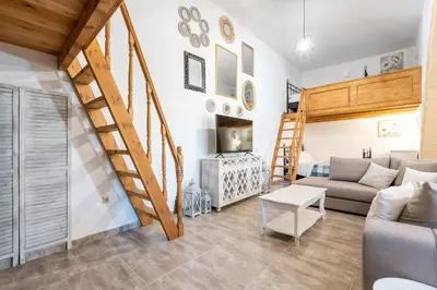 a living room with a staircase and a couch at Amalia's Traditional Home in Paradisi in Paradeísion