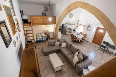 a living room with a couch and a table at Amalia's Traditional Home in Paradisi in Paradeísion