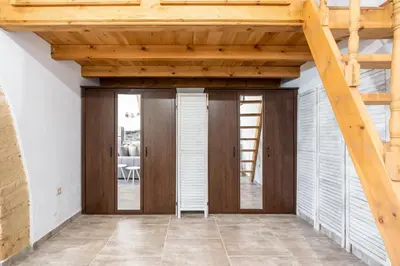 a room with wooden doors and a wooden ceiling at Amalia's Traditional Home in Paradisi in Paradeísion
