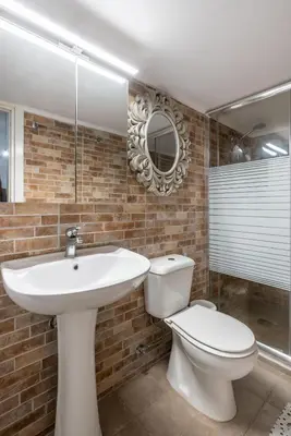 a bathroom with a sink and a toilet and a mirror at Amalia's Traditional Home in Paradisi in Paradeísion