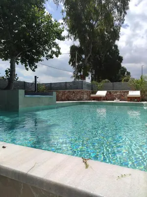 a large swimming pool with blue water at Luxury Villa Anemone with private pool in Pastida