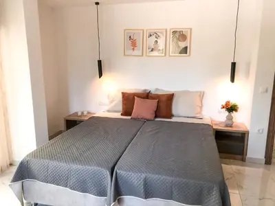 a bedroom with a large bed with pillows at Luxury Villa Anemone with private pool in Pastida