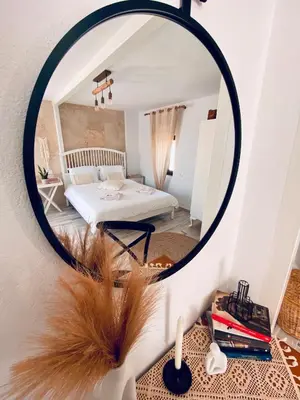 a bedroom with a mirror and a bed in a room at Nonna Cannella in Rhodes Town
