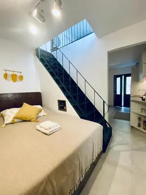 a bedroom with a bed and a staircase at Nonna Cannella in Rhodes Town