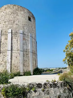 an old stone building with a fence around it at Nonna Cannella in Rhodes Town