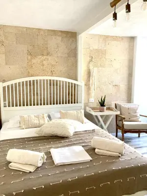 a bedroom with a large bed with pillows on it at Nonna Cannella in Rhodes Town