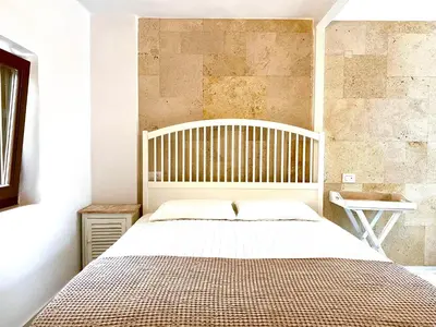 a bedroom with a large bed and a sink at Nonna Cannella in Rhodes Town