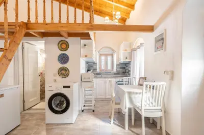 a kitchen and dining room with a table and chairs at Alicia's Traditional Home In Paradisi in Paradeísion