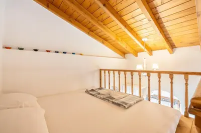 a bed in a room with a wooden ceiling at Alicia's Traditional Home In Paradisi in Paradeísion