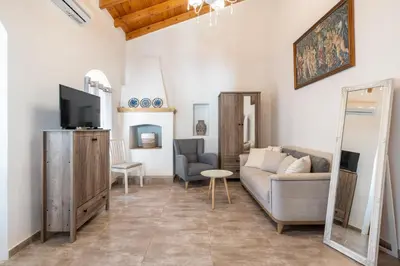 a living room with a couch and a tv at Alicia's Traditional Home In Paradisi in Paradeísion