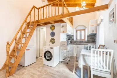 a kitchen and dining room with a staircase in a house at Alicia's Traditional Home In Paradisi in Paradeísion