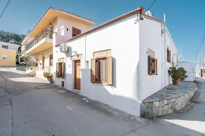 a white building on the side of a street at Alicia's Traditional Home In Paradisi in Paradeísion