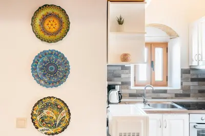 a kitchen with plates on the wall and a sink at Alicia's Traditional Home In Paradisi in Paradeísion