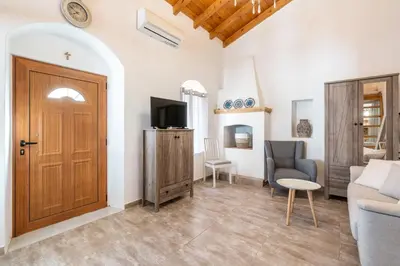 a living room with a door and a couch at Alicia's Traditional Home In Paradisi in Paradeísion