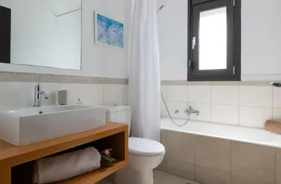 a bathroom with a sink and a toilet and a bath tub at Villa Athena with Private Pool and Seaview in Líndos