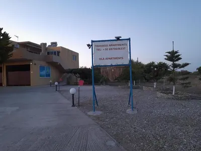 a sign in front of a building with a building at Green View Appartment (Thanasis 2) in Kalavárda