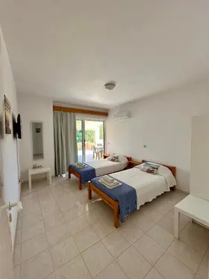 a bedroom with two beds and a balcony at Green View Appartment (Thanasis 2) in Kalavárda