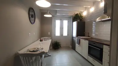 a kitchen with a counter and a table with wine glasses at Marietta's House in Rhodes Town