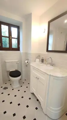a bathroom with a toilet and a sink and a mirror at Marietta's House in Rhodes Town